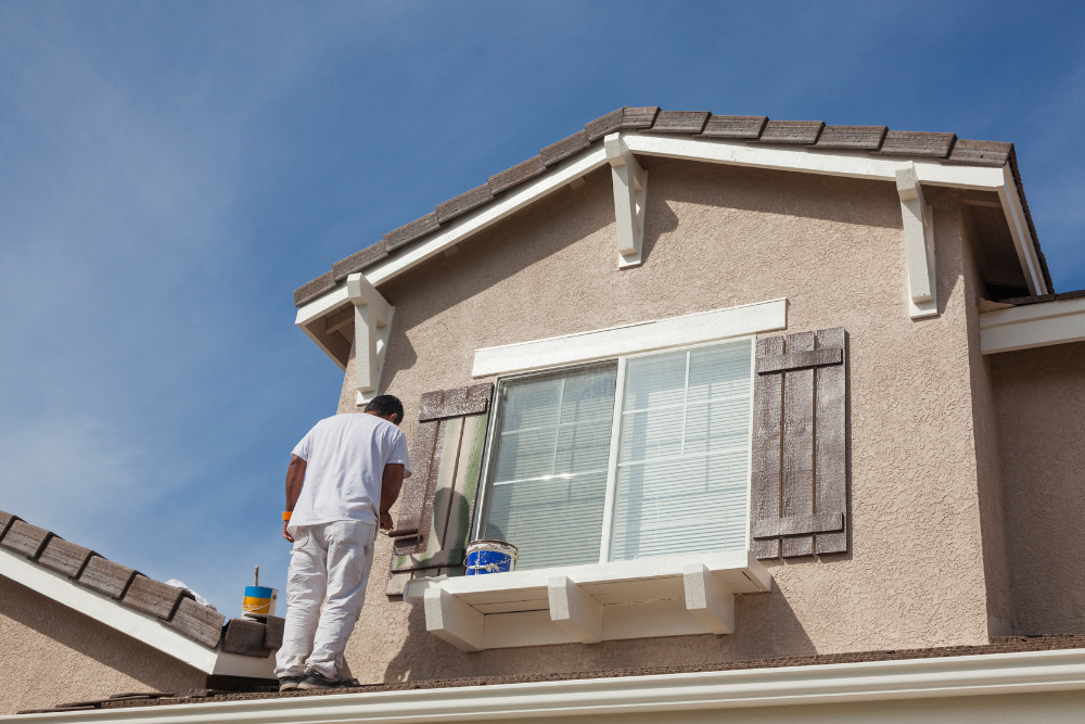 Professional Painter painting a home exterior